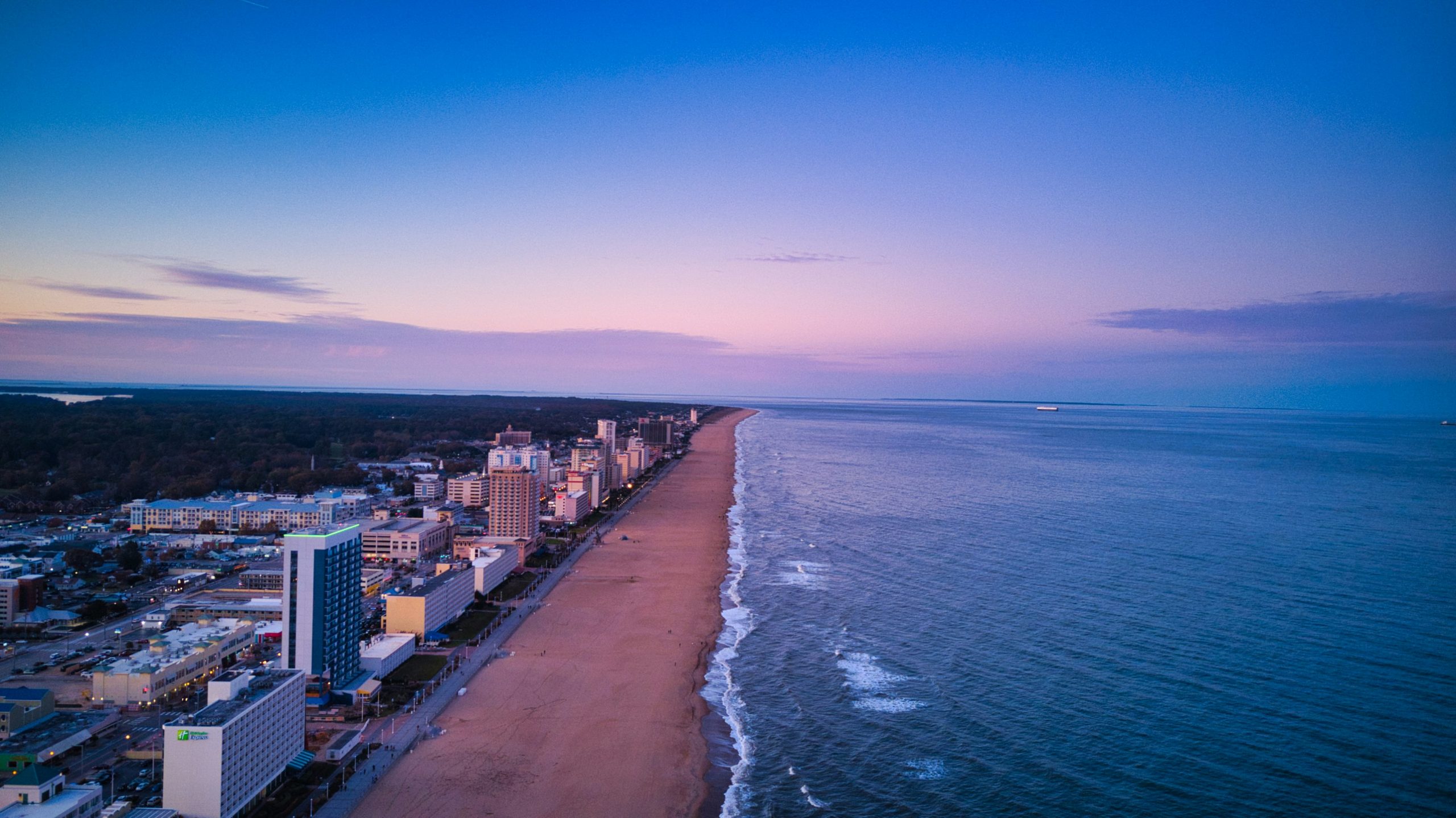 sunset over shoreline and waterfront city